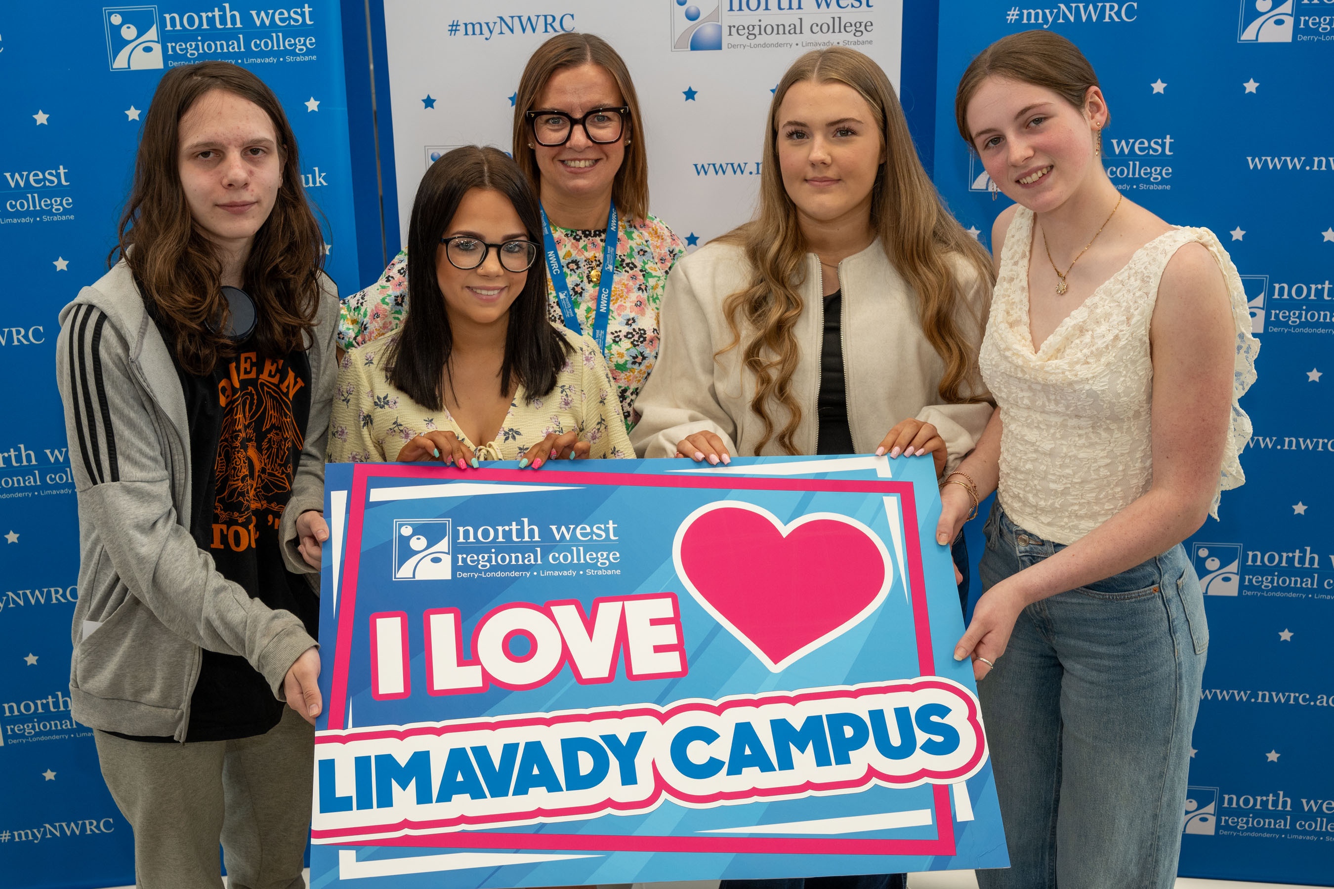 Five people at celebration event holding a I love Limavady sign
