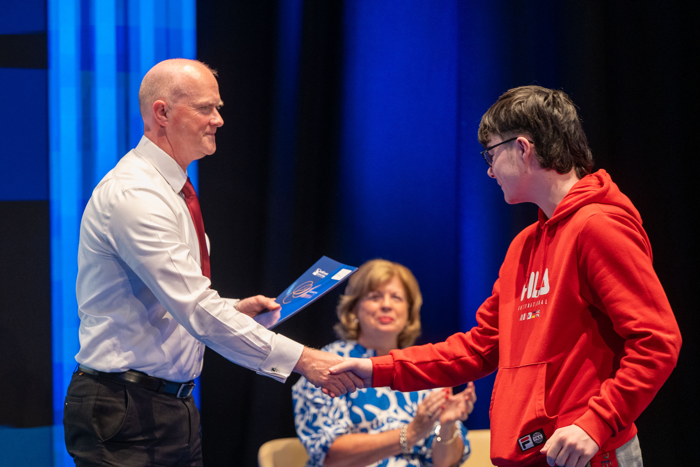 Student receives certificate on stage