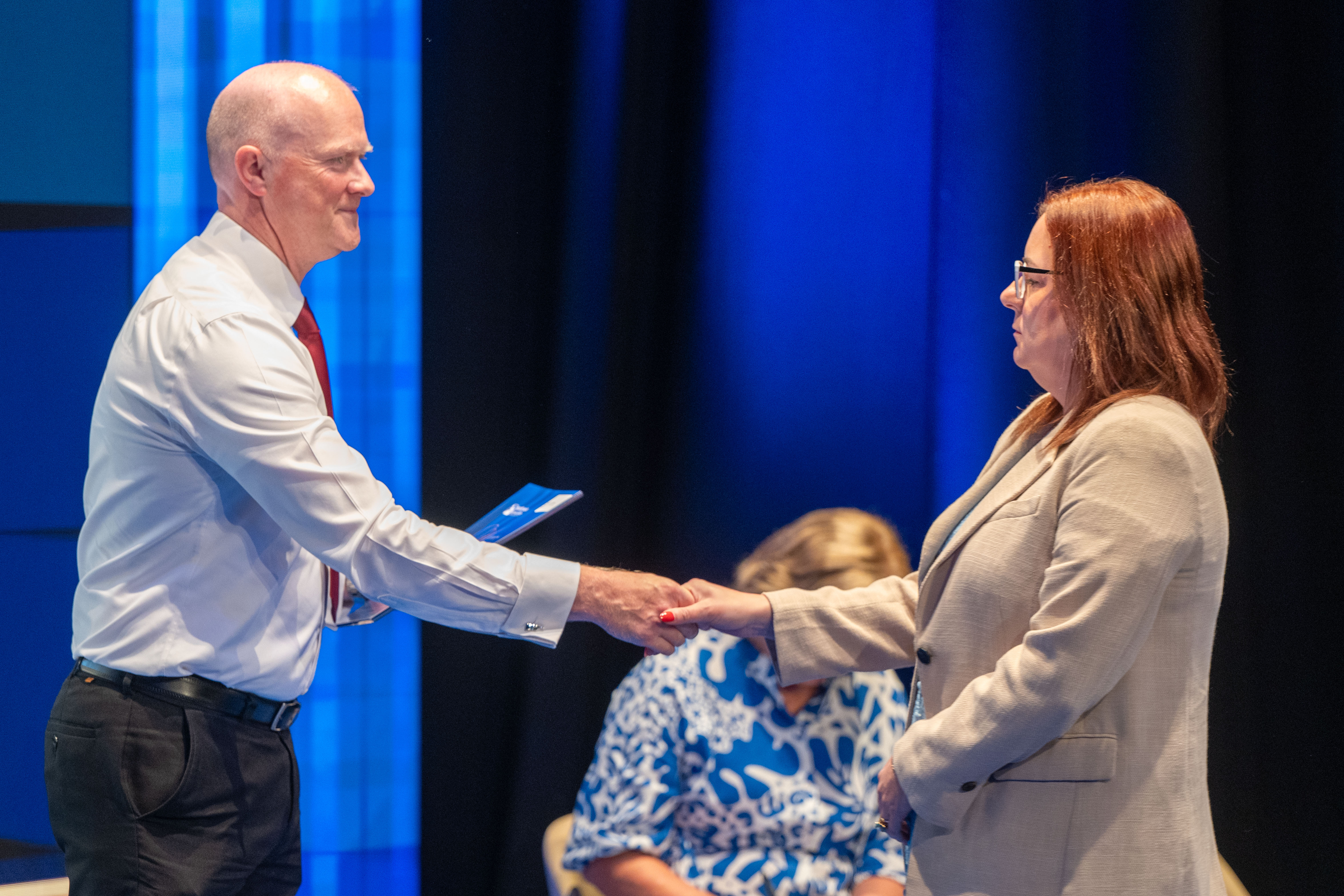 Student receives certificate on stage