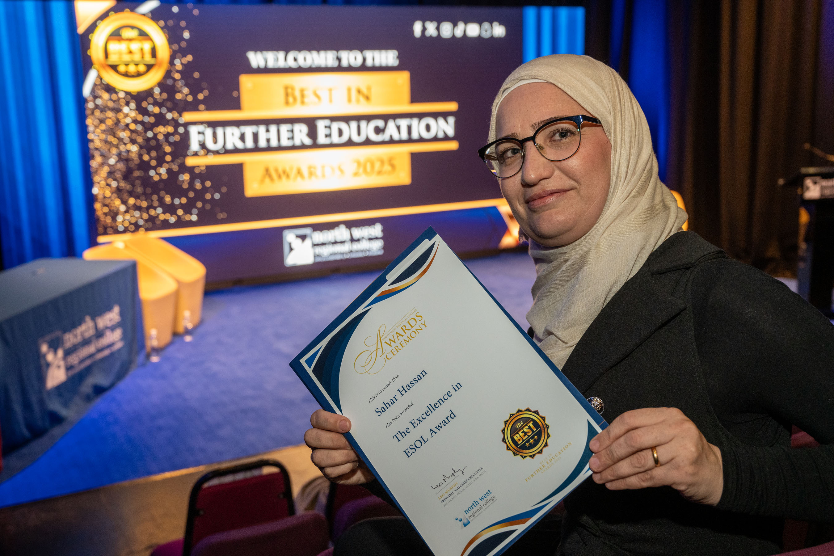 Student shows off certificate for excellence in ESOL