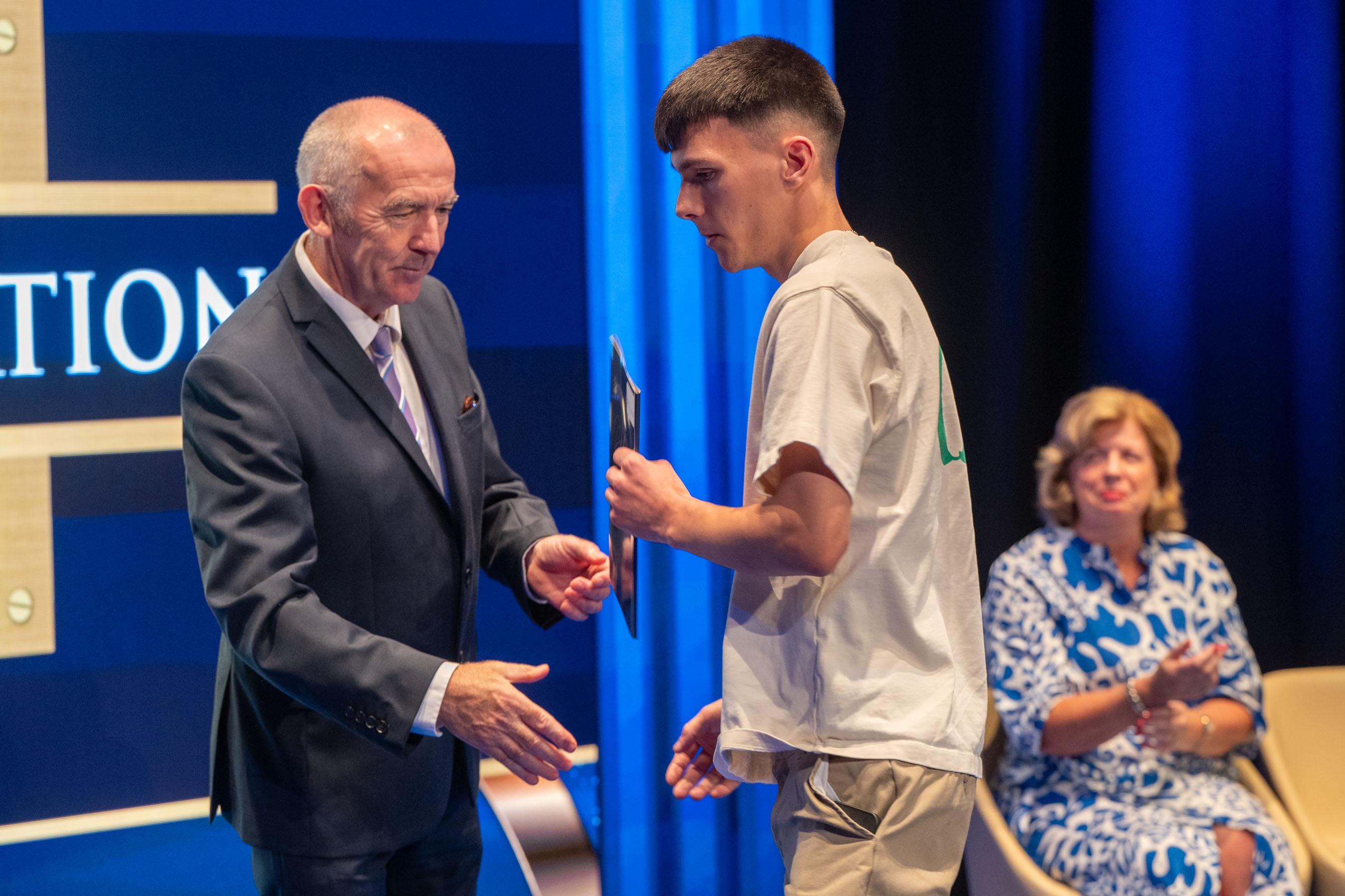 Student receives certificate on stage