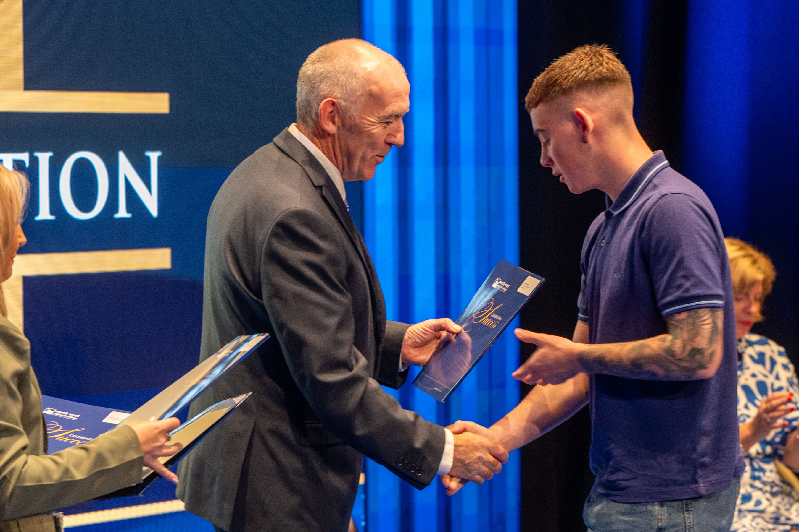 Student receives certificate on stage