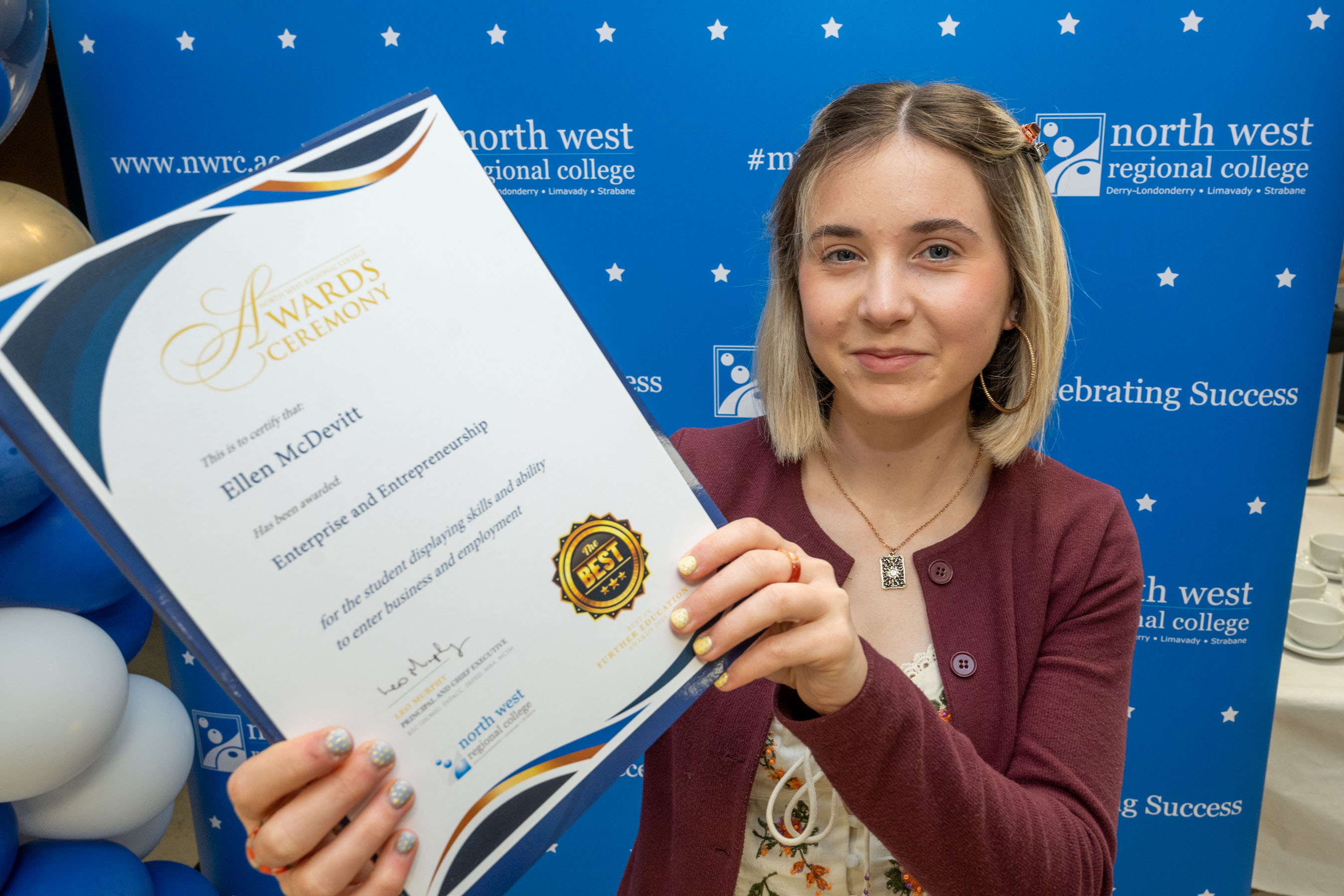 Student shows off certificate