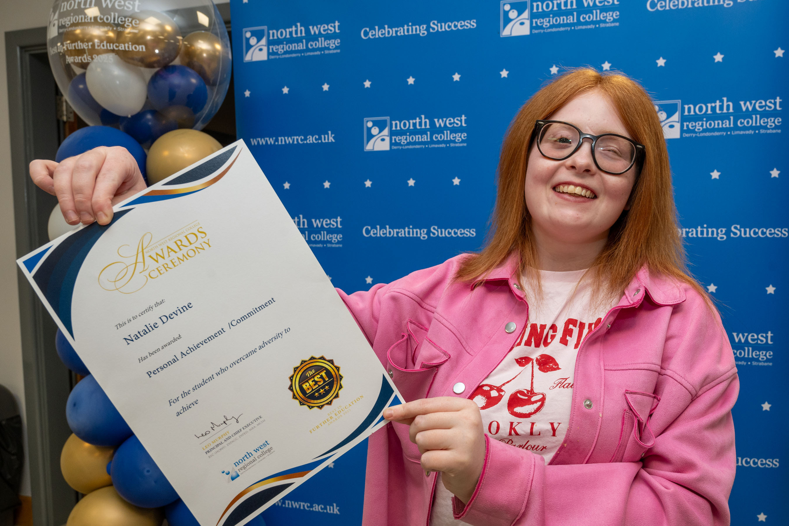 Student shows off certificate at awards ceremony. Its for personal achievement