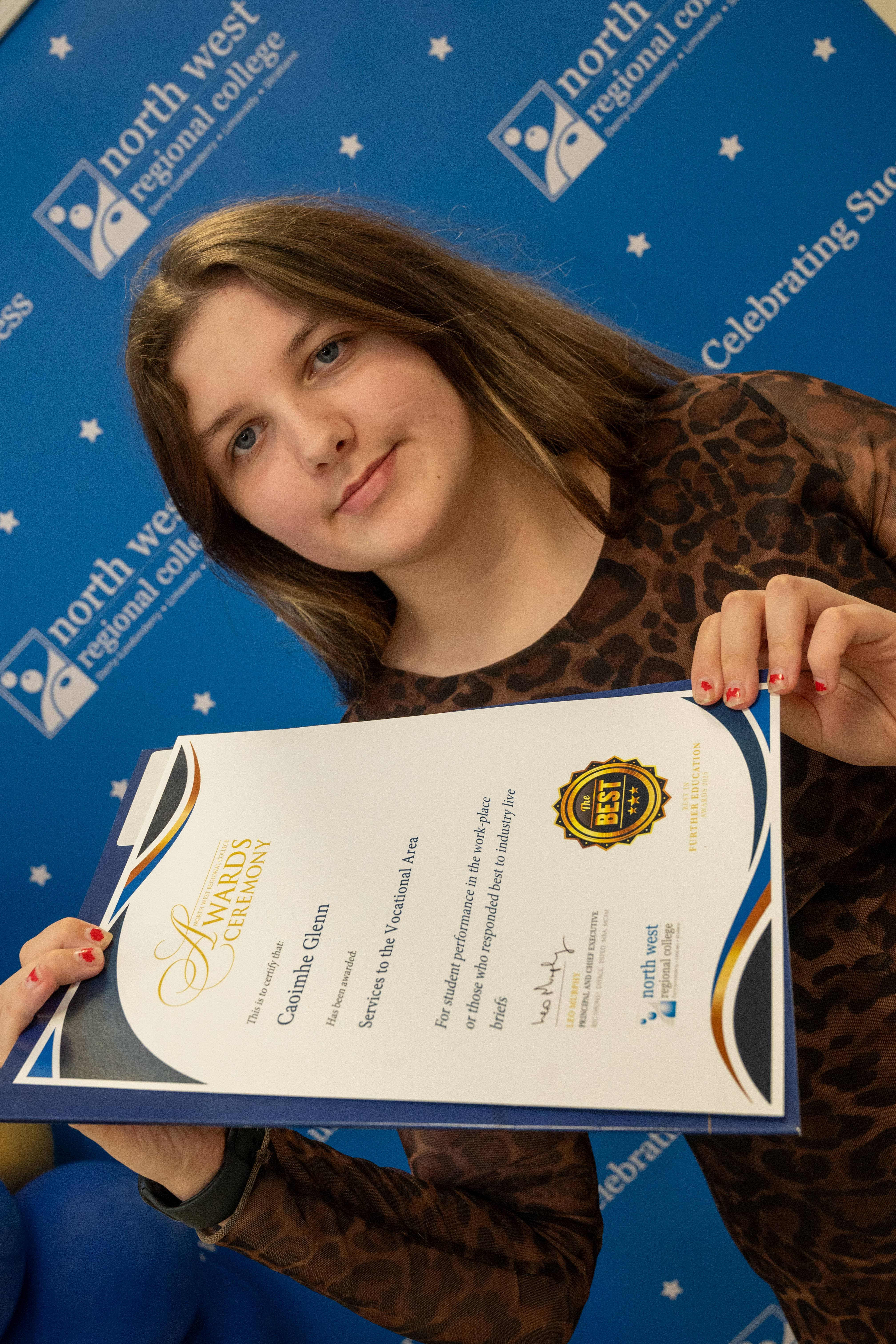 student shows off certificate