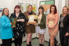 Students at art exhibition pictured holding an award