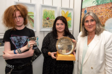 Two students and a lecturer with the award