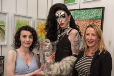 Two students and special guest hold award
