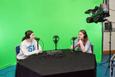Two female media students chatting and being filmed