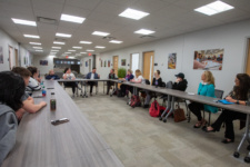 Students sitting behind tables in a classroom environment