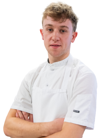 Blonde haired male student with white chef uniform