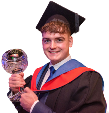 student at graduation holding a prize