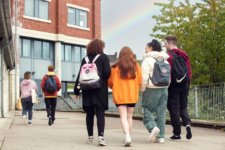Group of students walk towards Strand Road campus