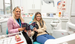 female sitting in dental chair with lecturer in the NWRC Strabane campus dental suite