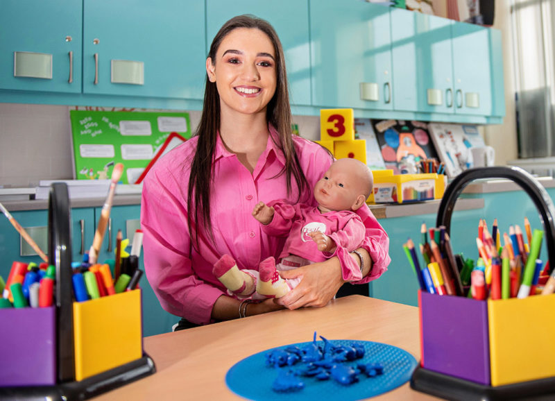 Early Years student Bridget Coyle nurses a Real Care Baby in the Childcare suite at NWRC
