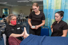 3 females in the NWRC beauty salon give a client a foot massage