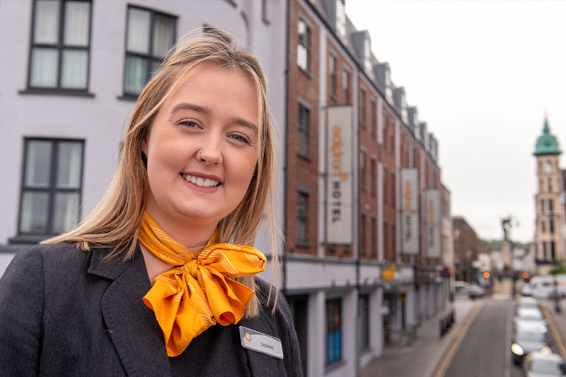 Former Hospitality Tourism student Caoimhe Deeney stands in front of the Maldron Hotel in Derry where she works as a receptionist