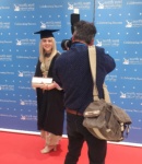 female graduate what her photo taken at the 2021 Graduation Ceremony