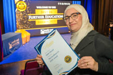 Syrian woman hold a certificate at college awards ceremony