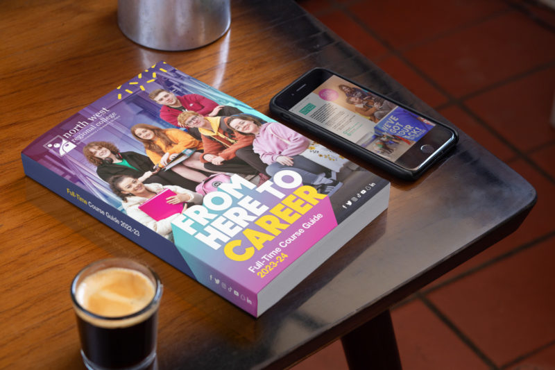 Mockup of Full Time Prospectus on a table with a phone and a coffee