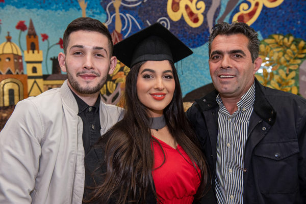 Female NWRC graduate with her father and brother