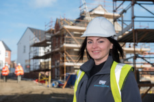 Female apprentice wearing safety helmet on construction site