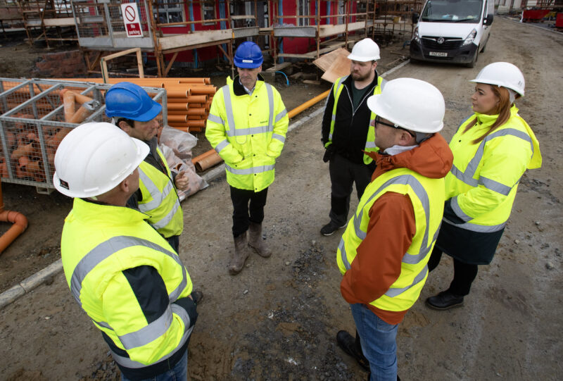 group in high vis and hard hats pictured on a construction site