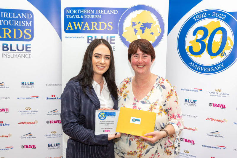 Female tourism student and her lecturer at awards ceremony holding the award