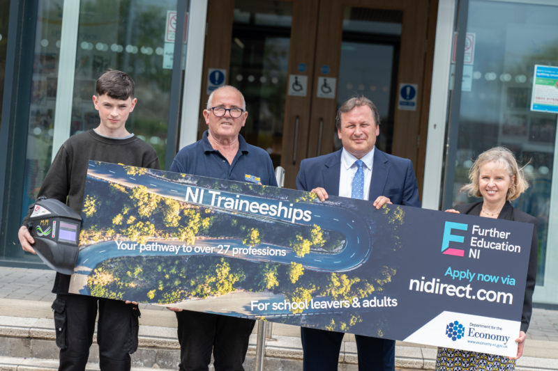 Group of people holding a sign promoting traineeships