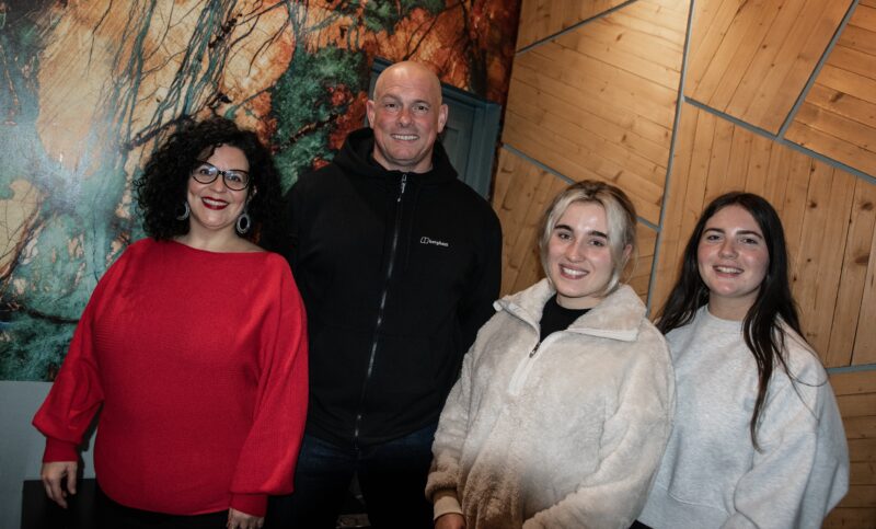 Man and woman pictured with two female students