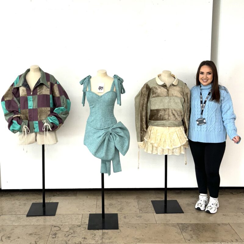 Woman looking at sustainable fashion designs on a mannequin