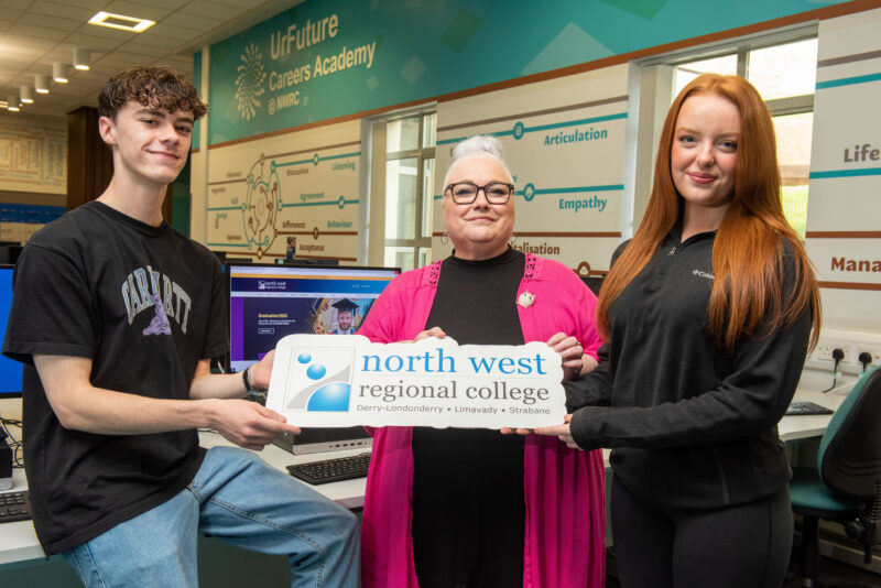 Three people pictured holding on a sign saying North West Regional college