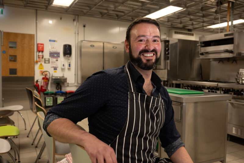 Chef sitting in  kitchen ready for a demo