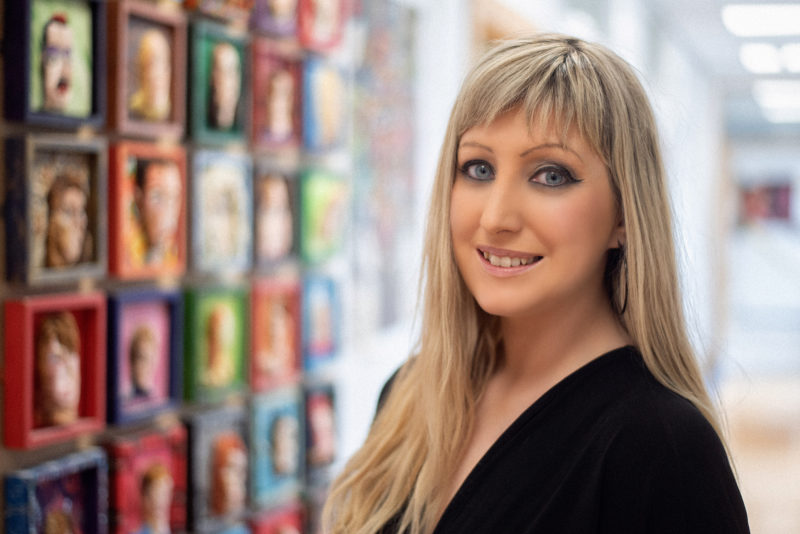 Female lecturer in the halls of the Art building at NWRC Limavady Campus