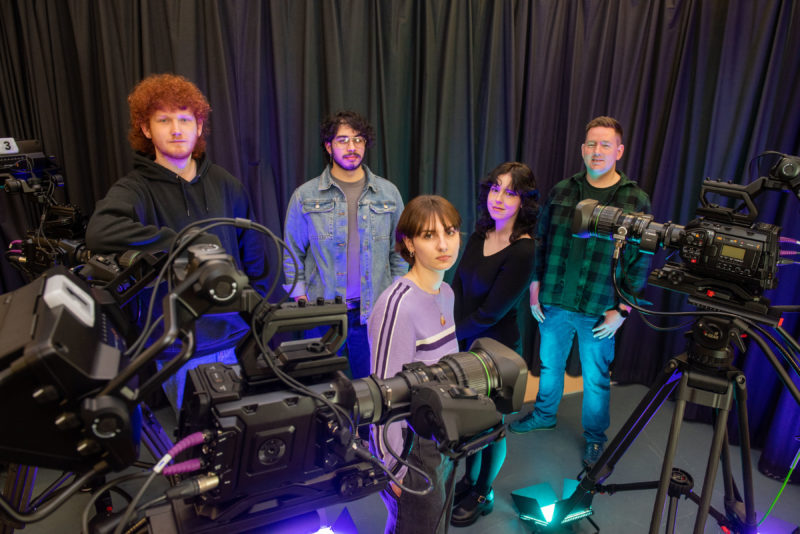 male and female students pictured with television cameras alongside their media lecturer