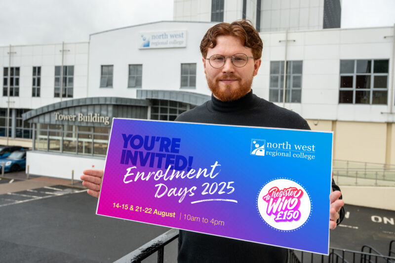 Man holding a colourful graphic promoting Enrolment days standing at the top of steps outside a college.