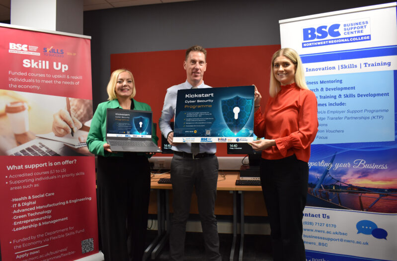 Three people holding signs for cyber security holding a laptop and ipad