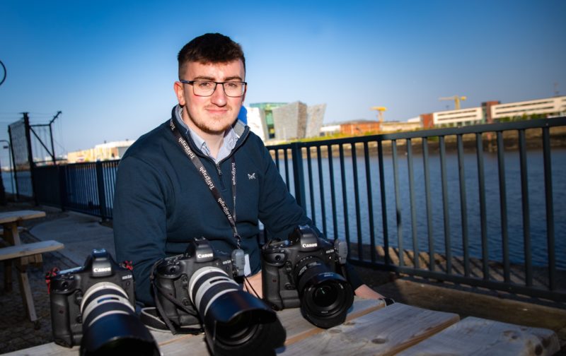 Man pictured on a quayside with cameras in front of him
