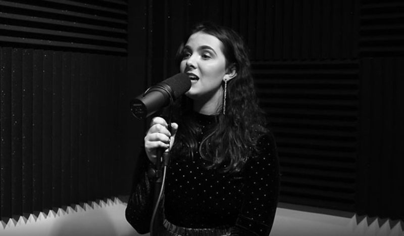 Female music student Juno Hasson, sings into a mic