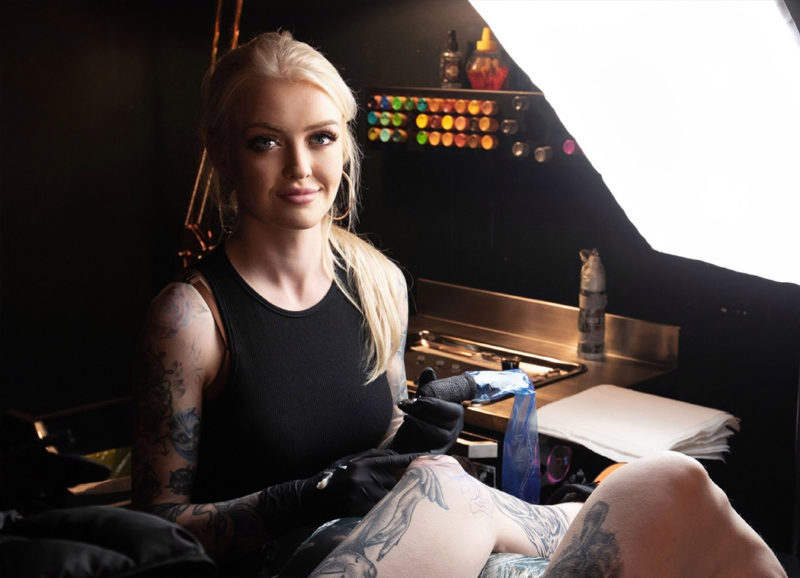 Abigail works on a client at her Tattoo Parlour, Amity Tattoo